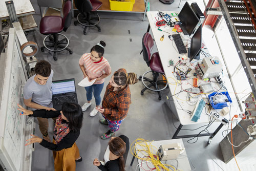 A male professor teaching students ai